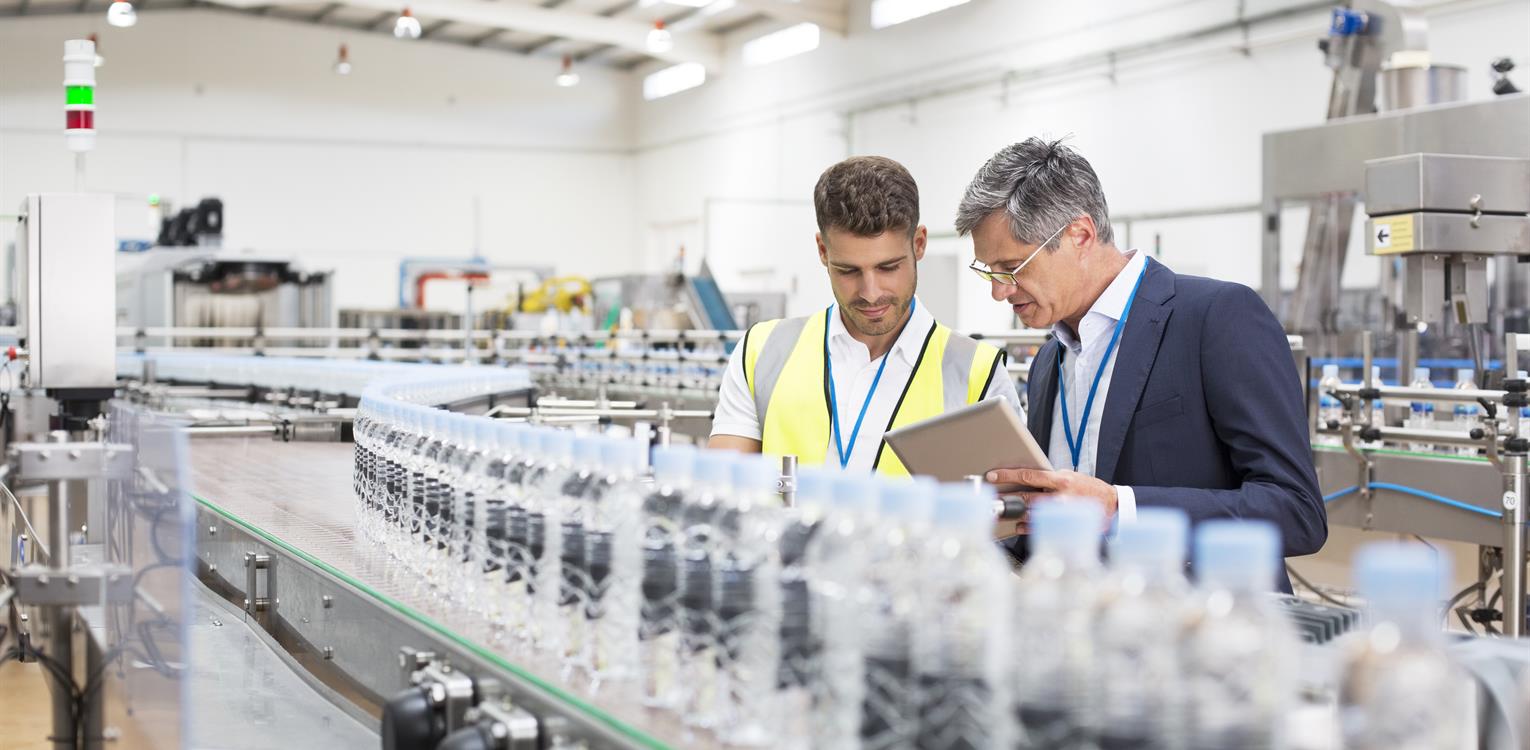 Image-picture-two-man-watching-plastic-bottles-on-conveyor-belt-20221107-GLO-EN